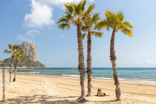 Obraz na płótnie Calpe. Spain's Costa Blanca coast. A city beach with palm trees and a peak called Penon de Ifach (Little Giblartar) holiday landscape w salonie
