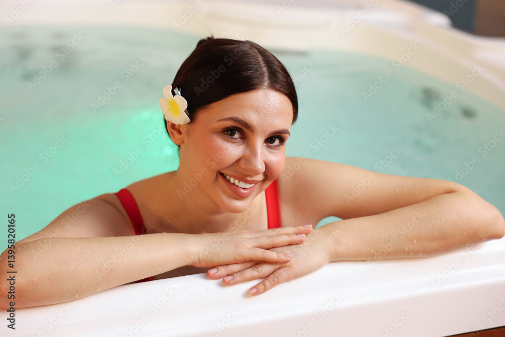 Beautiful woman relaxing in hot tub indoors Beautiful woman relaxing in hot tub indoors