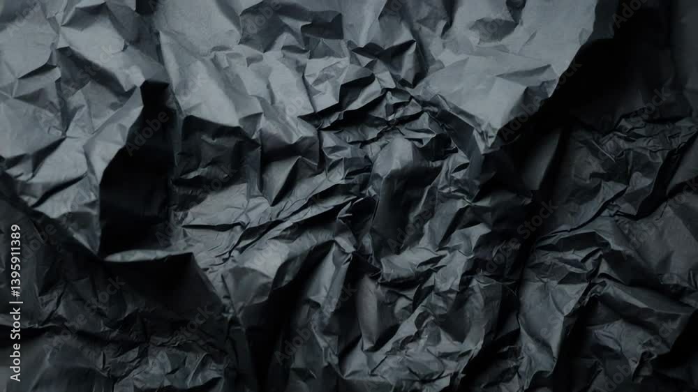 Black paper backdrop with a wrinkled texture Black paper backdrop with a wrinkled texture