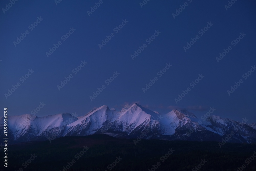 The snow-capped peaks of the High Tatras mountains in sunrise light from viewpoint Pass over Lapszanka (Pass over Łapszanka), Podhale, Poland