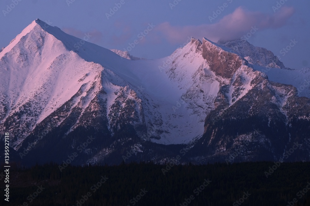 The snow-capped peaks of the High Tatras mountains in sunrise light from viewpoint Pass over Lapszanka (Pass over Łapszanka), Podhale, Poland