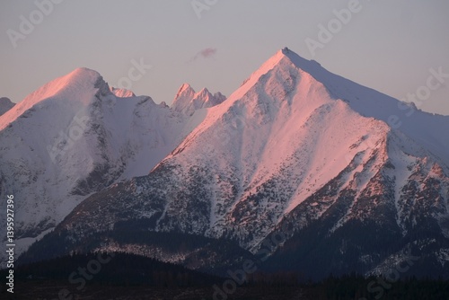 The snow-capped peaks of the High Tatras mountains (Havran and Placliva Skala) in sunrise light from viewpoint Pass over Lapszanka (Pass over Łapszanka), Podhale, Poland photo