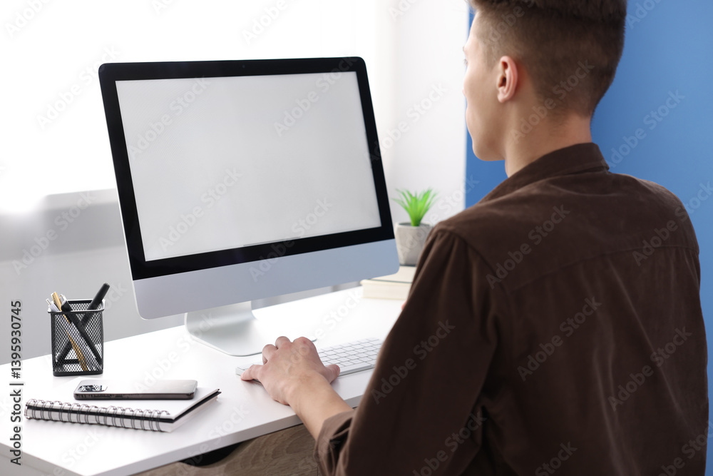 Man working on computer at white desk in office. Mockup for design Man working on computer at white desk in office. Mockup for design