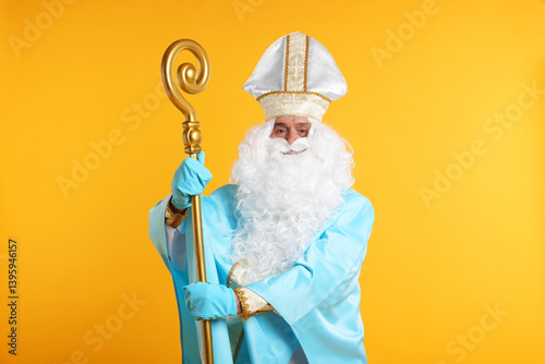 Saint Nicholas with crozier on orange background photo