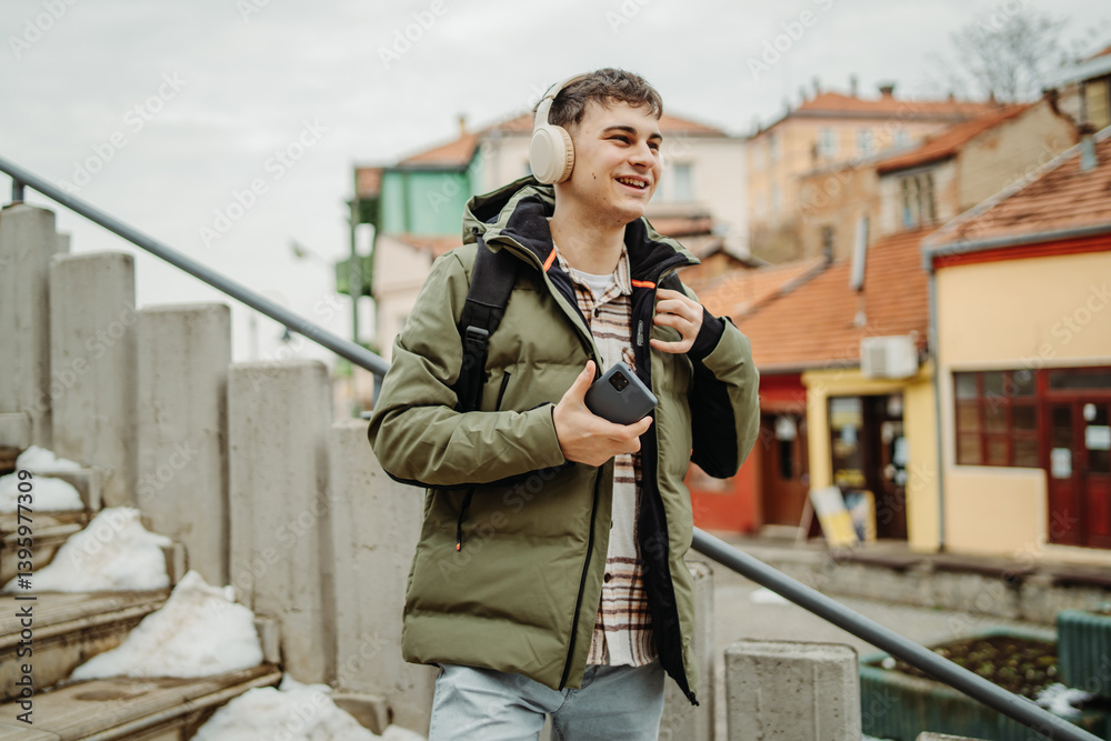 Young adult caucasian man student smile and use phone to take self portrait or video call