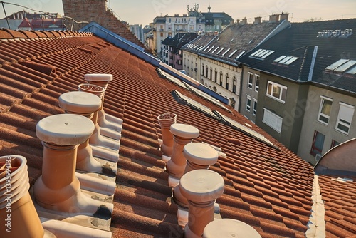 Obraz na płótnie Tiled city building roofs with air vent pipes w salonie