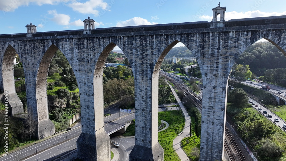 Fototapeta premium Aguas Livres Aqueduct At Lisbon In Lisbon District Portugal. Water System. Historic Engineering. Aguas Livres Aqueduct At Lisbon In Portugal. Medieval Aqueduct. Public Transport. Portugal Skyline.