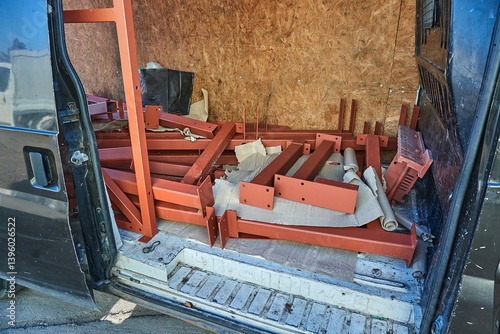 Steel bracket sections for building construction hauled in a van cargo hold