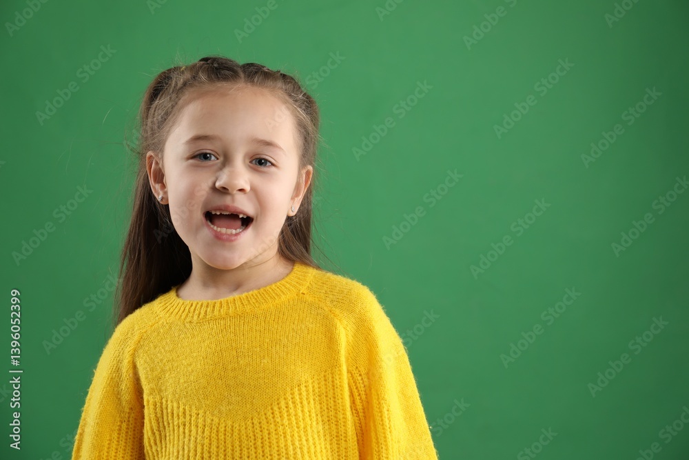 Portrait of cute little girl with missing tooth on green background, space for text Portrait of cute little girl with missing tooth on green background, space for text