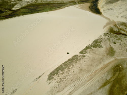 Aerial shot from sand dunes with buggy in national park of Jericoacoara, Ceará state, Brazil.