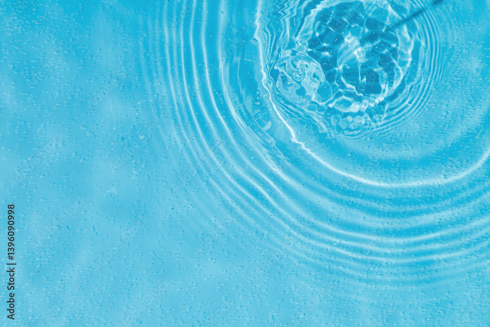 drops on water with circles on a blue background