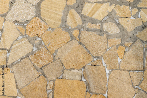 Obraz na płótnie Yellow and beige mosaic-style stone wall offering a rough texture w salonie