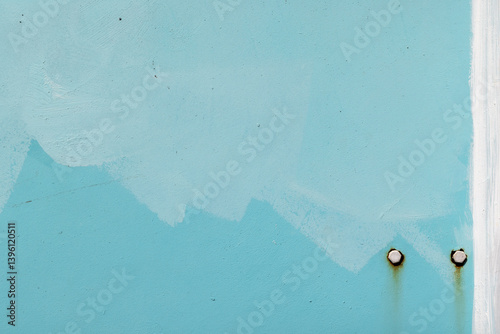 Obraz na płótnie A textured close-up photo of a light blue metal wall with two rusty bolts w salonie