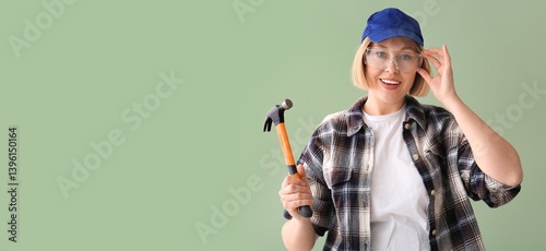 Female worker with hammer o...