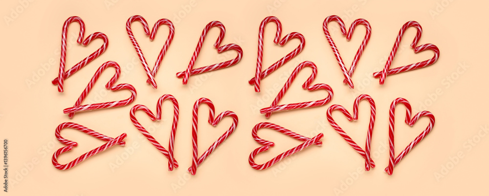 Hearts made of Christmas candy canes on yellow background Hearts made of Christmas candy canes on yellow background