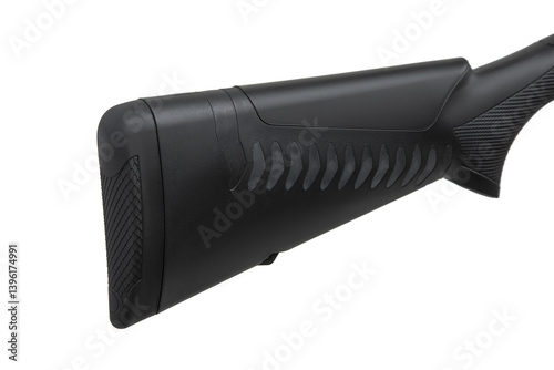 Photography A close-up view of a black synthetic rifle stock with a textured grip and recoil pad