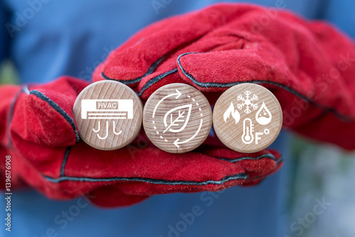 Obraz na płótnie Hands in protective gloves holding wooden blocks with icons symbolizing concept: HVAC. Concept of HVAC or Heating Ventilation Air Conditioning. HVAC engineering. w salonie