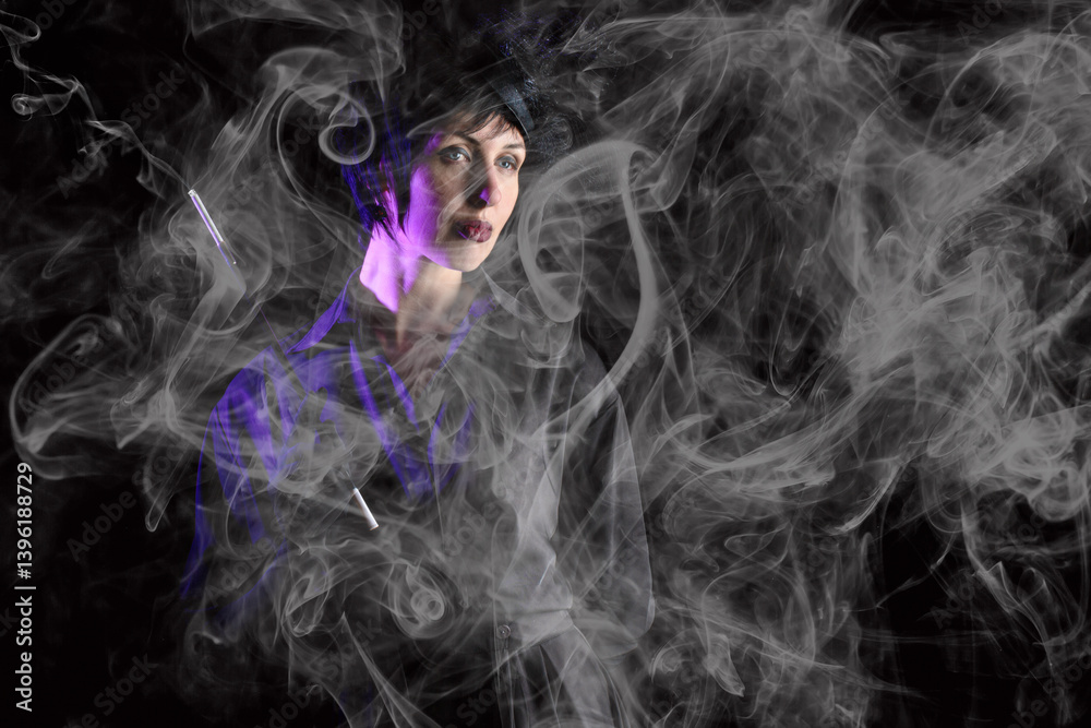 Retro noir style. Dramatic portrait of a beautiful charming brunette smoking woman in black dress with mouthpiece against black background in smoke.