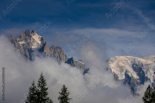 Aiguille du Midi peak in the Alps. Chamonix valley landscape of a prominent rocky towering mountain peak in French Alps. Chamonix-Montblanc area beautiful landscape of Aiguille du Midi summit, France
