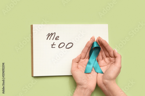 Female hands holding teal r...