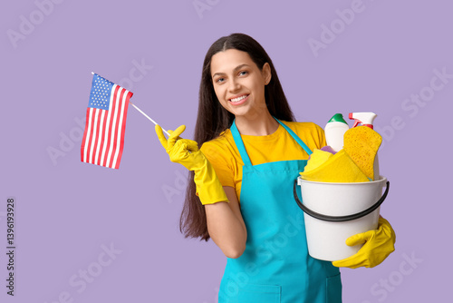 Female janitor holding buck...