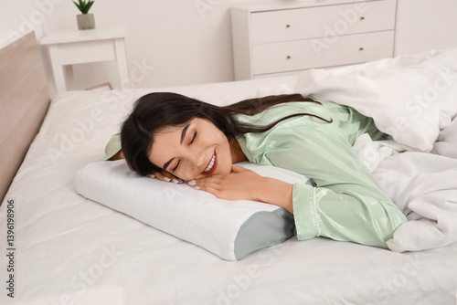 Young woman in pajamas lyin...