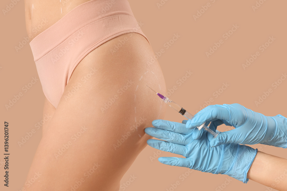 Plastic surgeon with injection and marks on woman's butt against beige background, closeup Plastic surgeon with injection and marks on woman's butt against beige background, closeup