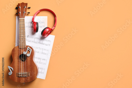 Obraz na płótnie Ukulele, modern headphones and music sheets on color background w salonie