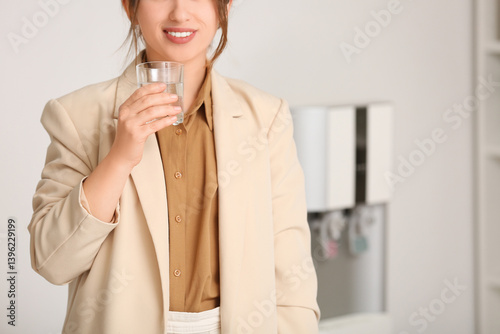 Beautiful young woman drink...