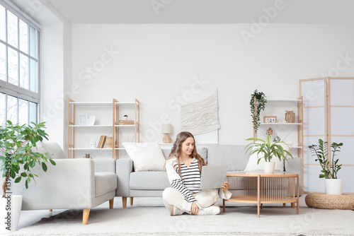 Young woman using laptop on...