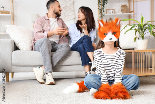 Little girl in a fox mask a...