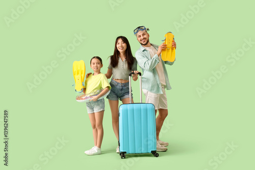 Happy family with beach acc...