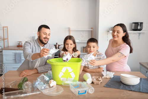 Family sorting paper garbag...