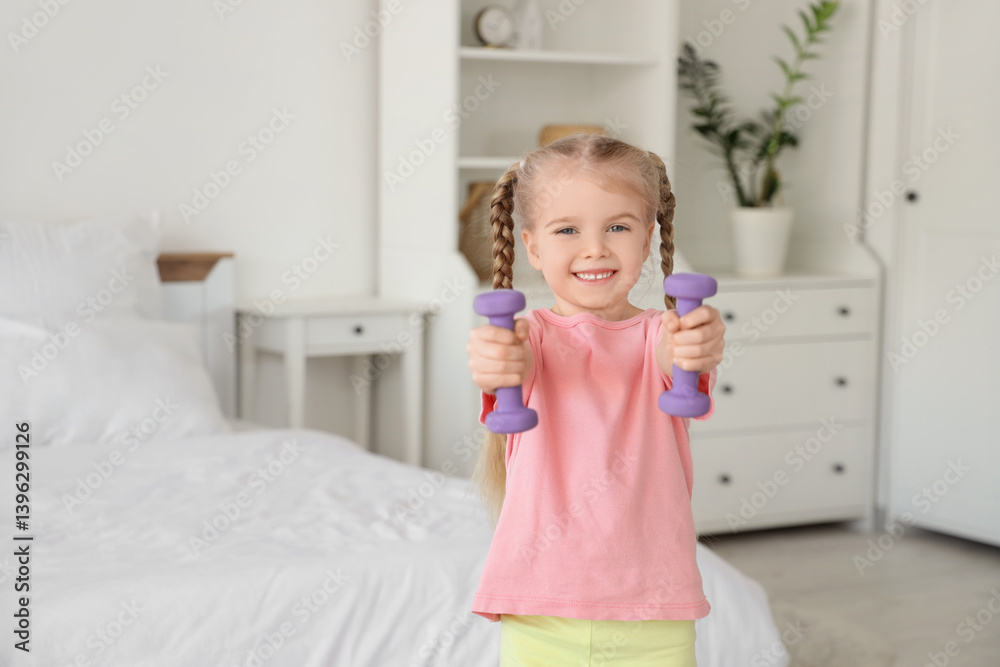Sporty little girl with dumbbells training in bedroom Sporty little girl with dumbbells training in bedroom