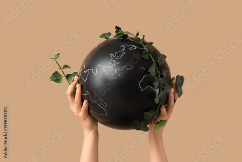 Female hands with globe and...