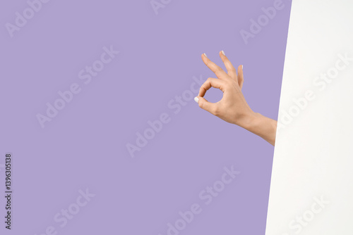 Female hand showing OK with...
