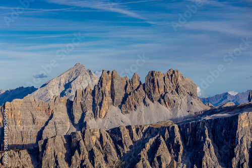 Dolomites, Alpi Dolomiti beautiful scenic mountain landscape under blue sky in summer. Rocky tower peak summits of the Alps on a sunny day. Alpine scenic view of the cliffs and climbing walls in Italy