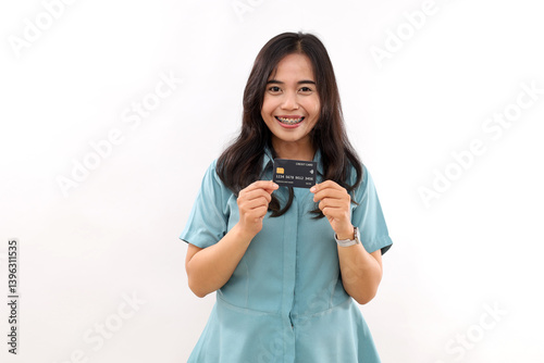 Photo of impressed adorable cute young woman dressed shirt holding bank card isolated white color background