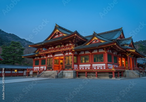 A traditional japanese building with red and white accents under a twilight sky landscape view