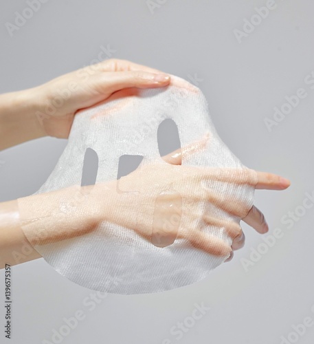 Moist hands that are spreading their mask packs