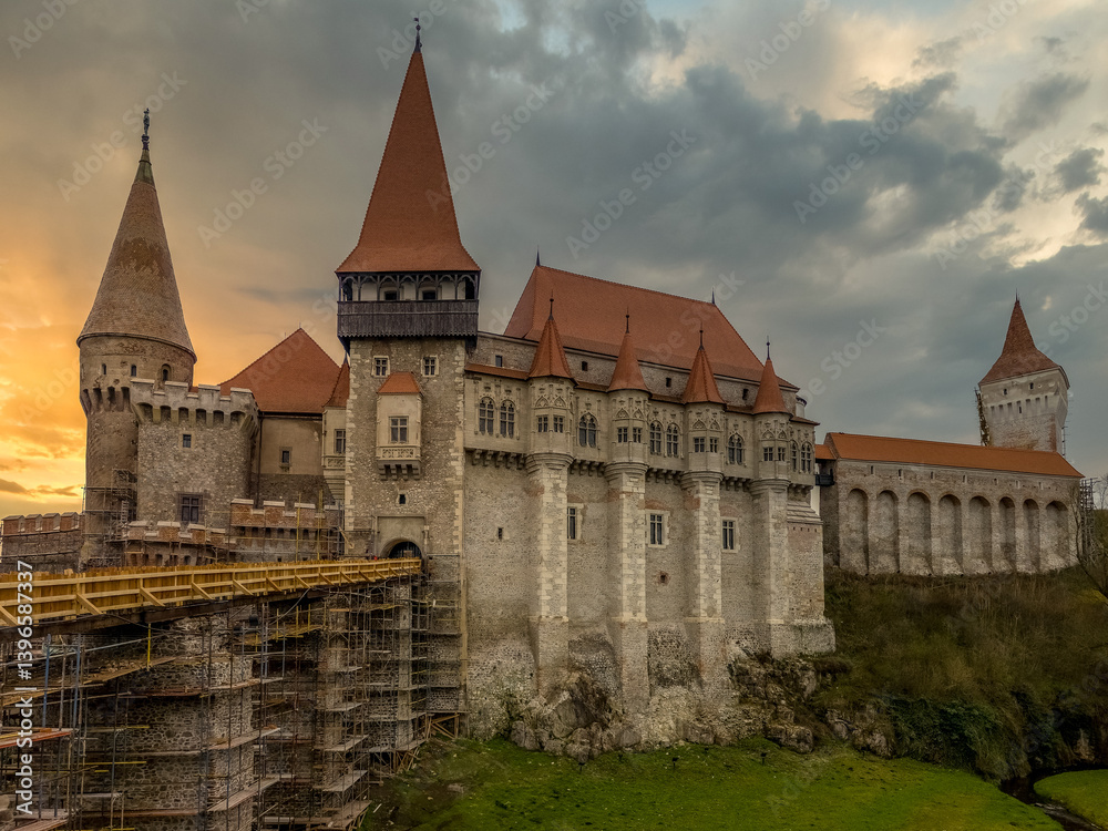 A Detailed Look at the Towers and Battlements of Corvin Castle in Hunedoara, Vajdahunyad castle Romania with sunset sky
