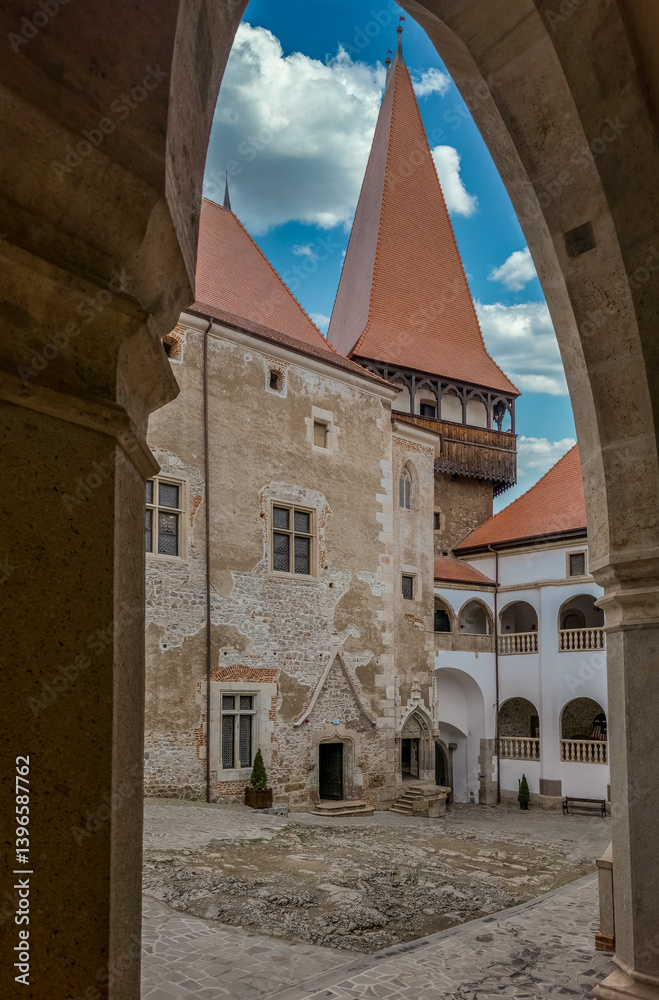 Inner courtyard of Hunedoara Vajdahunyad castle with Gothic and Renaissance palace and gate tower through the arches