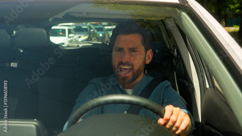 Angry irritated Caucasian man annoyed businessman male guy driver stuck traffic jam road accident problem driving honk car horn sound signal beep steering wheel shout anger displeased drive automobile