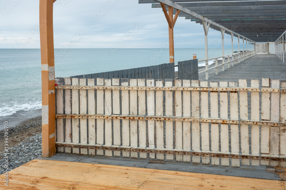 A wooden fence is on the beach