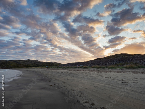 Sunseton on the beach in Teriberka, on the Barents Sea in the Murmansk region of northern Russia photo