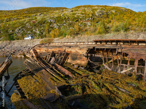 The cemetery of old ships is a landmark in Teriberka, on the Barents Sea in the Murmansk region of northern Russia photo