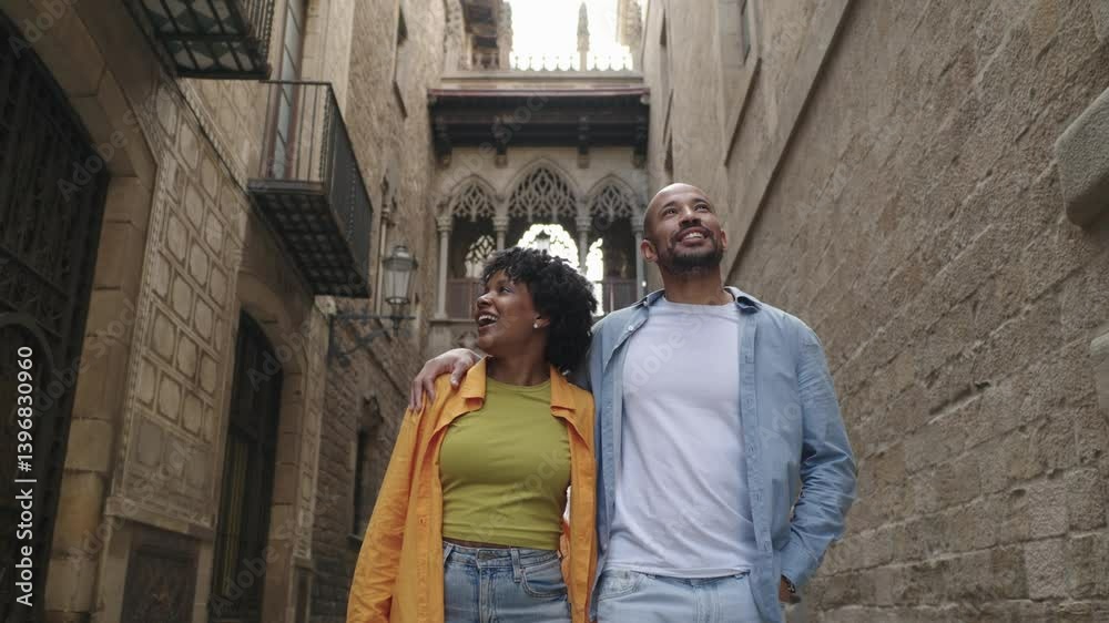 Tourists walking and admiring barcelona's gothic quarter Tourists walking and admiring barcelona's gothic quarter