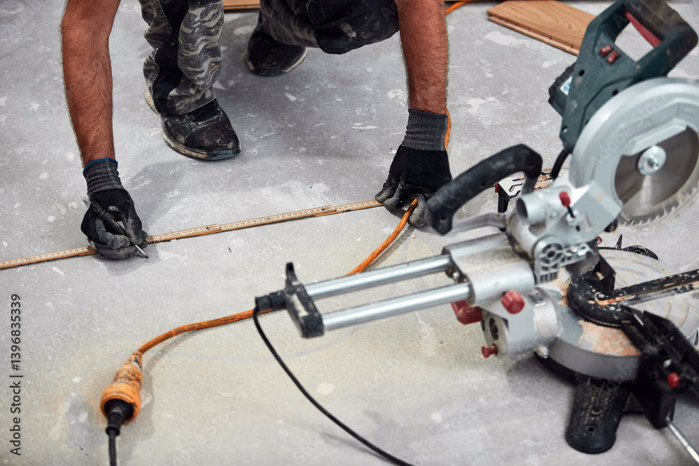 Professional handyman installing laminate flooring in a new apartment.
