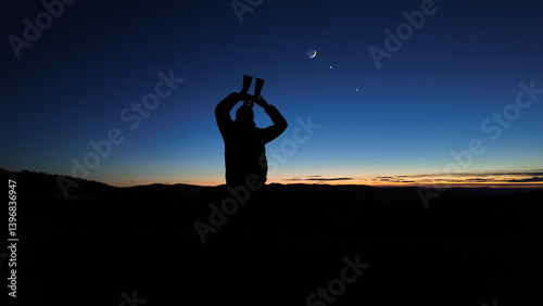 Obraz na płótnie Amateur astronomer looking at the evening skies, observing planets, stars, Moon and other celestial objects with binoculars. w salonie