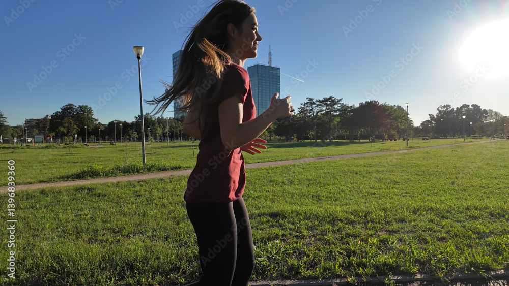 Young woman running and jogging in urban park Slow motion video..
